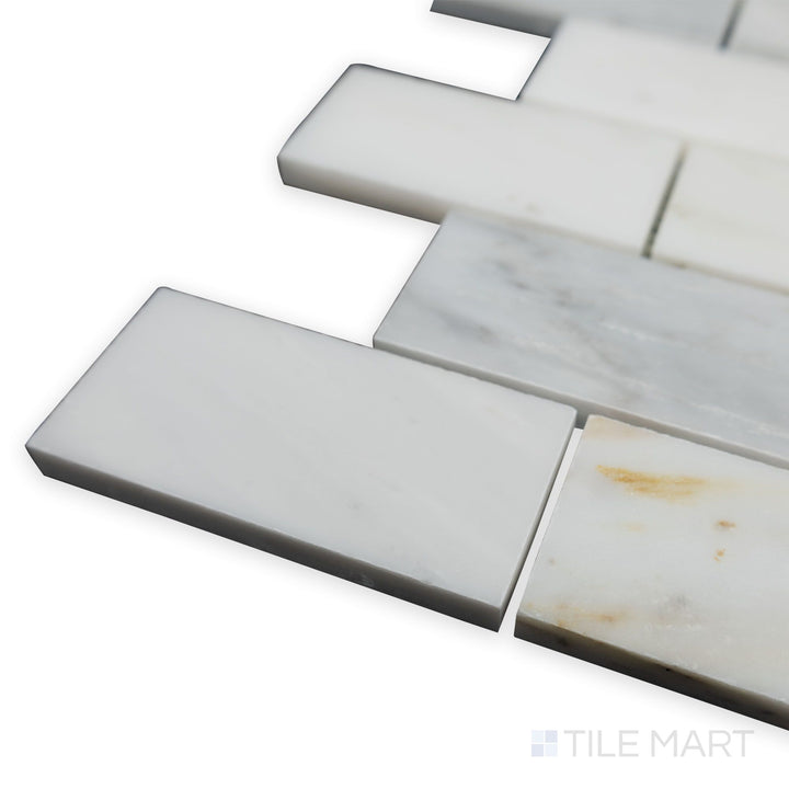 A detailed corner perspective of Oriental White Marble 2x4 brick honed mosaic showcases its enlarged brick layout and non-reflective surface for a modern yet timeless appeal.