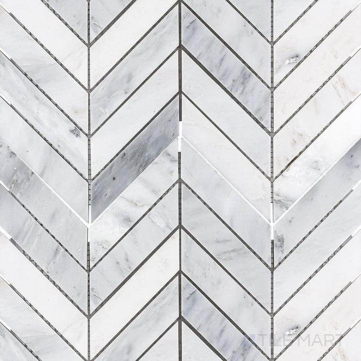 Flat-lay shot of Oriental White Marble 1x4 chevron honed mosaic, showcasing a dynamic chevron pattern with a refined matte texture.