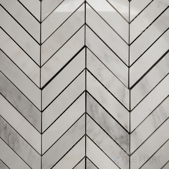 Top-down view of Oriental White Marble 1x4 chevron polished mosaic, featuring a striking chevron pattern with a glossy, elegant finish.