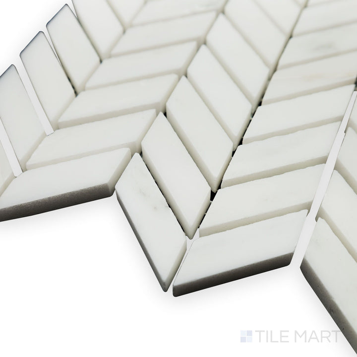 A sleek corner shot of Oriental White Marble Mini Chevron polished mosaic highlights its intricate V-shaped pattern and glossy surface for a sophisticated touch.