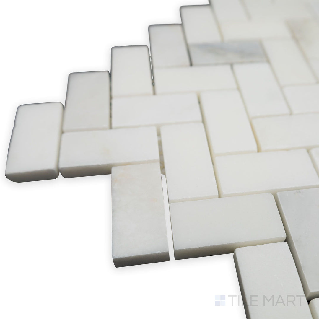 A corner perspective showcases the flowing herringbone pattern of Oriental White Marble 1x2 honed mosaic, where its honed finish adds a natural, understated charm.