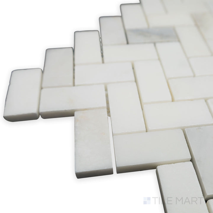 A corner perspective showcases the flowing herringbone pattern of Oriental White Marble 1x2 honed mosaic, where its honed finish adds a natural, understated charm.
