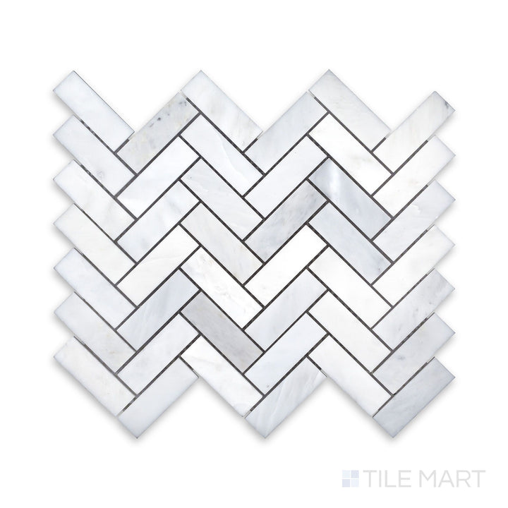 An up-close perspective of Oriental White Marble 1X3 Herringbone Honed Mosaic, showcasing the natural stone details in a dynamic arrangement.