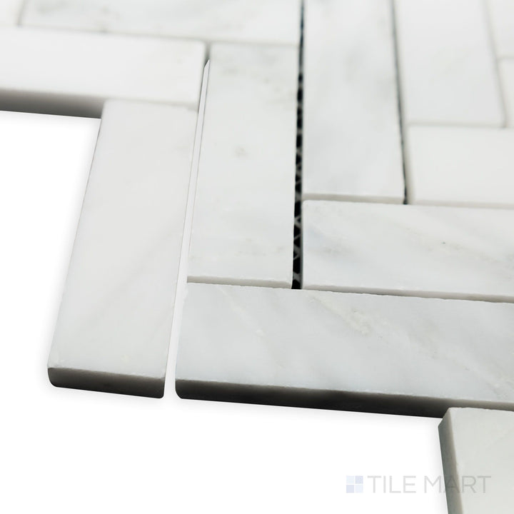 A detailed corner shot highlights the elongated design of Oriental White Marble 1x3 Herringbone honed mosaic, bringing depth and character to the arrangement.