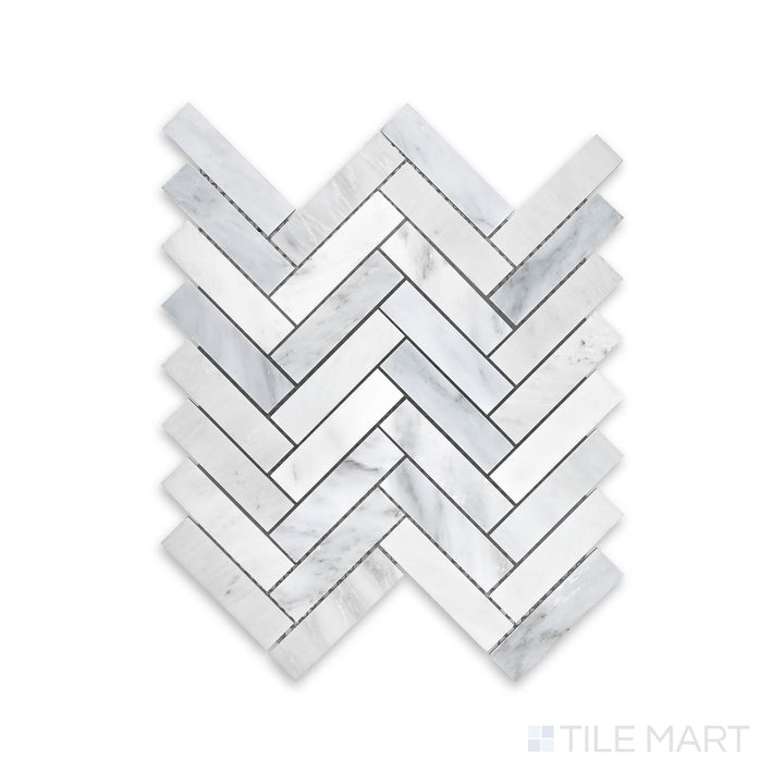 A finely detailed close-up of Oriental White Marble 1X4 Herringbone Honed Mosaic, featuring a classic herringbone layout with a matte surface.