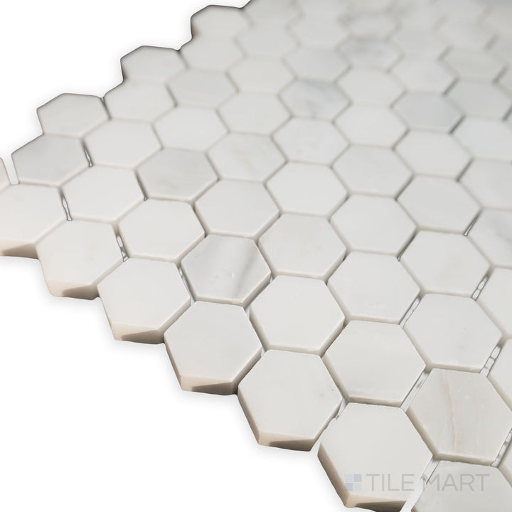 A geometric arrangement comes to life in this corner shot of Oriental White Marble 1" Hexagon honed mosaic, showcasing its matte finish and crisp lines.