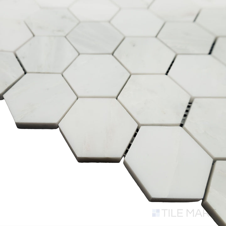From a stylish side angle, the Oriental White Marble 2" Hexagon honed mosaic highlights its refined pattern with a non-reflective surface for a subtle elegance.