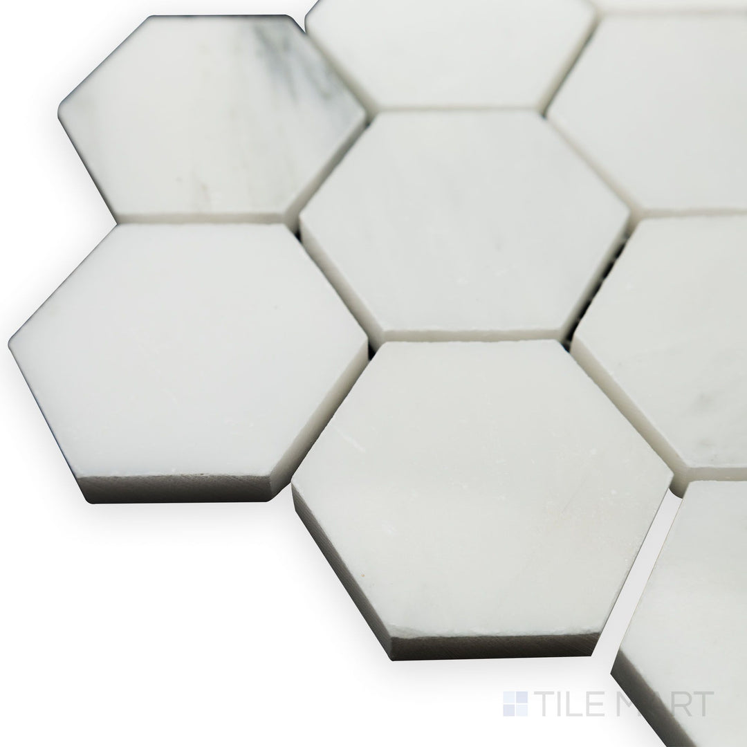 Light catches the polished edges in this corner shot of Oriental White Marble 2" Hexagon polished mosaic, emphasizing its crisp white finish and delicate veining.