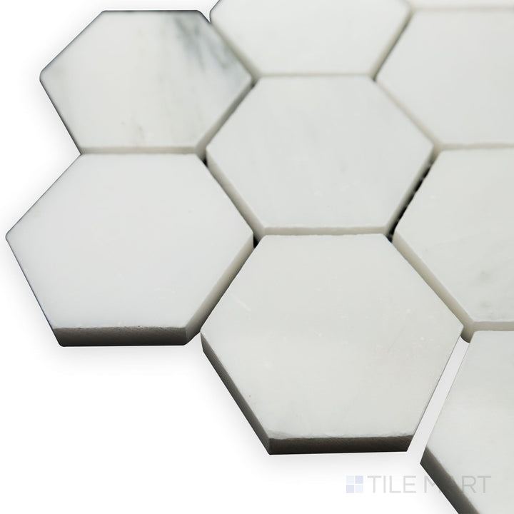 Light catches the polished edges in this corner shot of Oriental White Marble 2" Hexagon polished mosaic, emphasizing its crisp white finish and delicate veining.