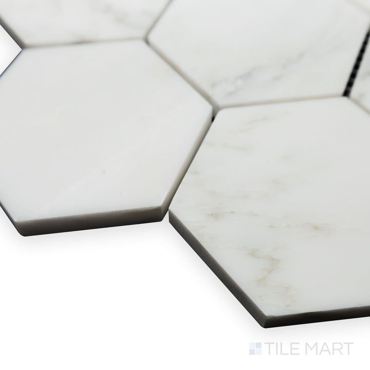 A structured design takes center stage in this angled corner perspective of Oriental White Marble 3" Hexagon honed mosaic, where its matte texture adds depth.