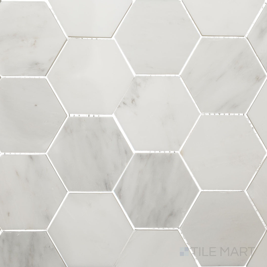 Overhead image of Oriental White Marble 3" hexagon polished mosaic, featuring a luxurious polished surface that accentuates the white and grey veining.