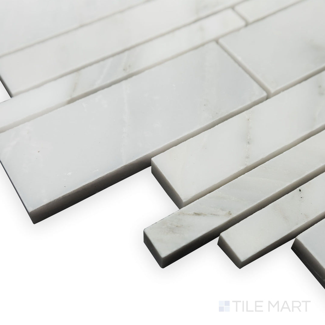 A polished surface enhances the seamless layout of Oriental White Marble Linear polished mosaic in this corner shot, creating a clean and sophisticated look.