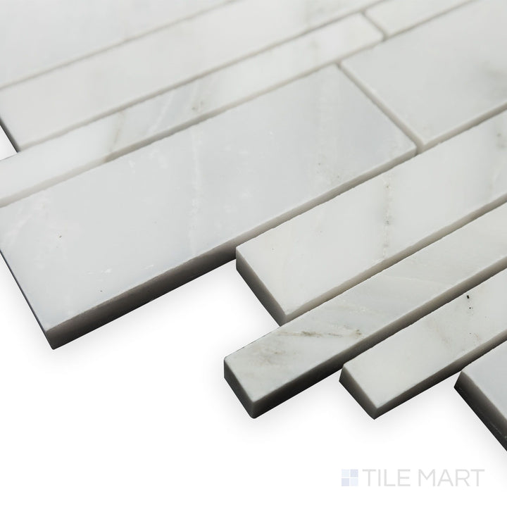 A polished surface enhances the seamless layout of Oriental White Marble Linear polished mosaic in this corner shot, creating a clean and sophisticated look.