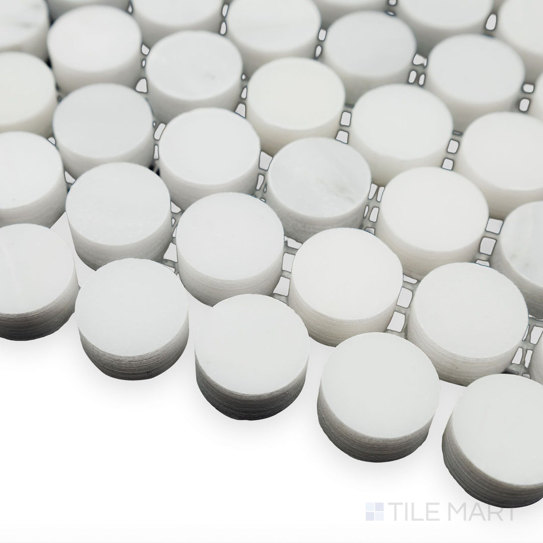 A timeless penny round pattern is captured in this soft corner angle of Oriental White Marble 3/4" Penny Round honed mosaic, where its matte texture complements classic design.