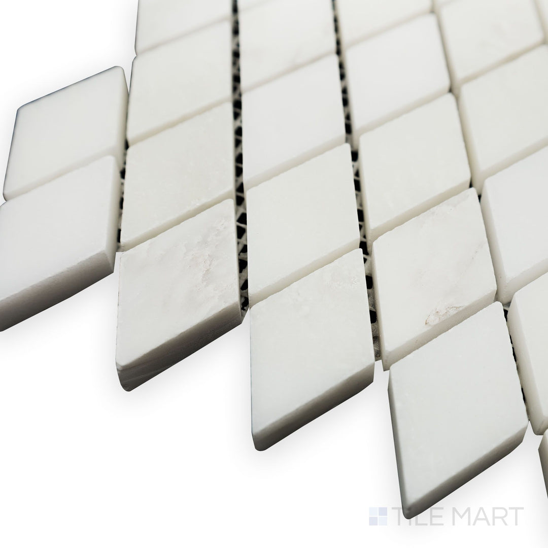 From a structured side view, the Oriental White Marble Rhomboid honed mosaic displays its geometric precision with a soft, honed finish for a contemporary touch.