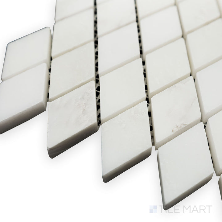 From a structured side view, the Oriental White Marble Rhomboid honed mosaic displays its geometric precision with a soft, honed finish for a contemporary touch.
