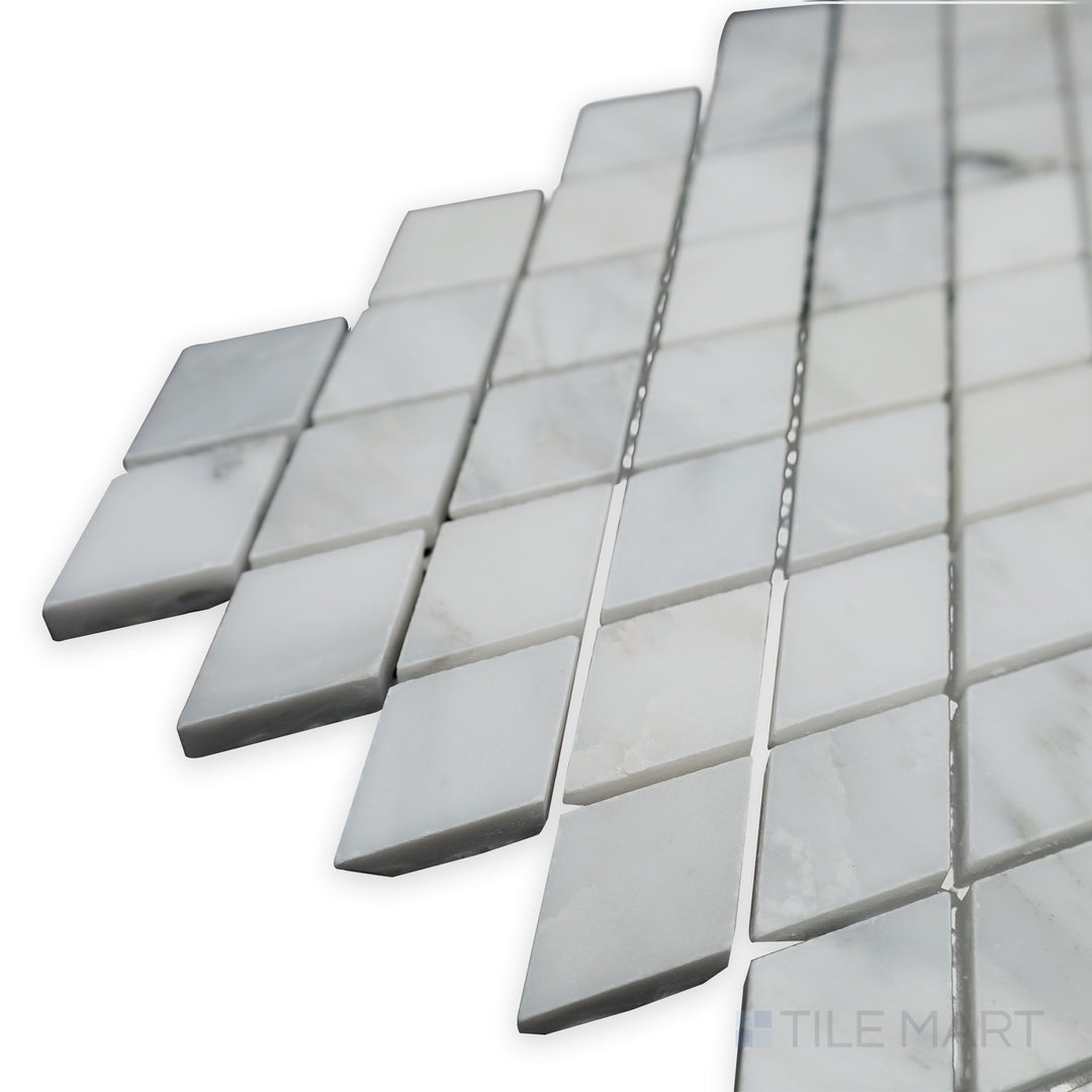 A polished geometric pattern takes shape in this angled corner shot of Oriental White Marble Rhomboid polished mosaic, reflecting light for a sleek modern look.