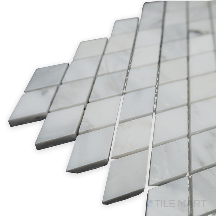 A polished geometric pattern takes shape in this angled corner shot of Oriental White Marble Rhomboid polished mosaic, reflecting light for a sleek modern look.