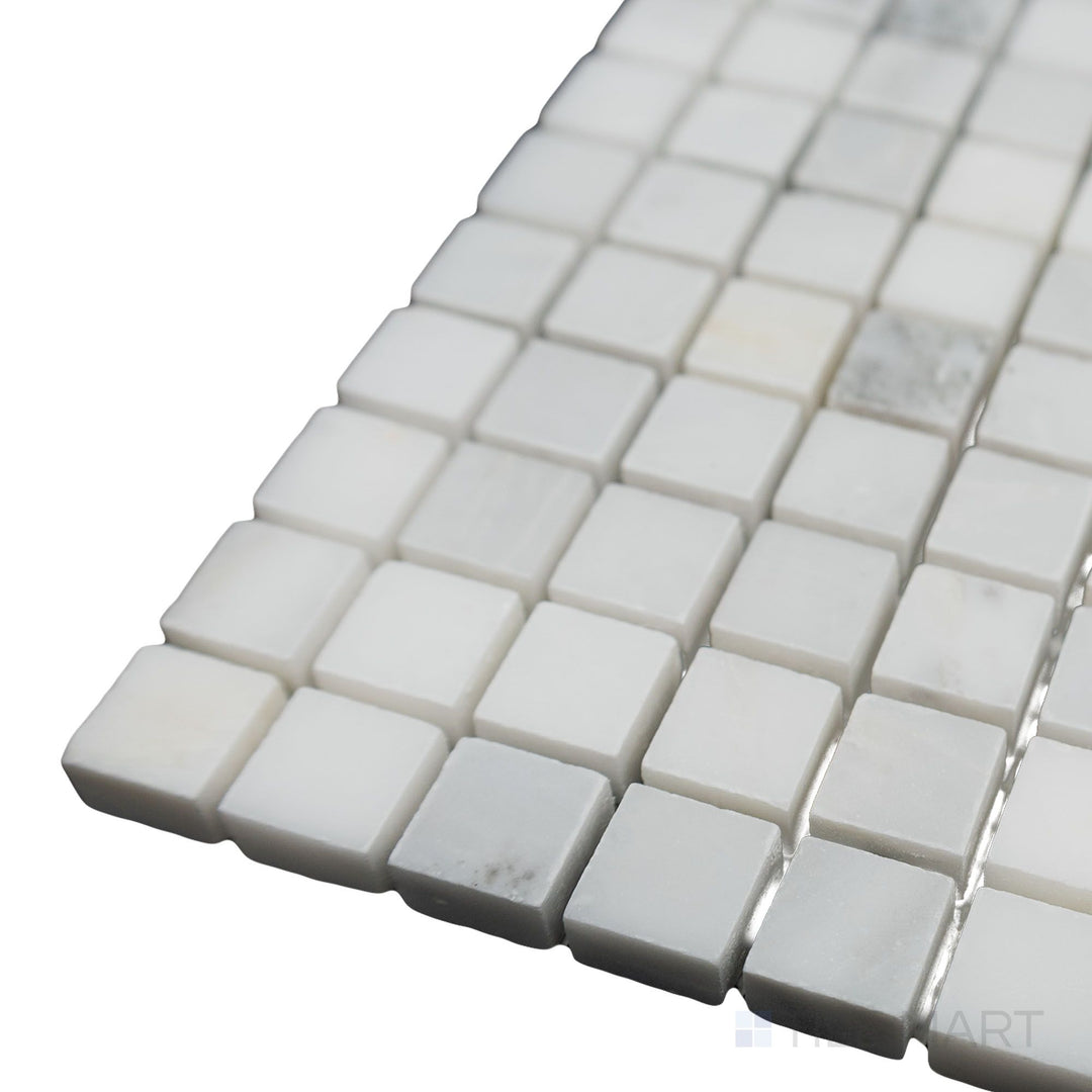 A clean and structured layout is highlighted in this close-up corner shot of Oriental White Marble 5/8" Square honed mosaic, where its matte finish adds a refined elegance.