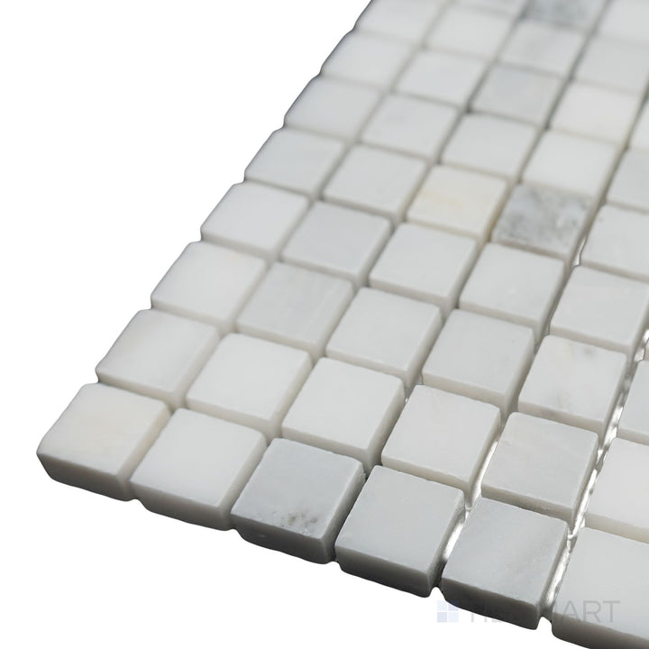 A clean and structured layout is highlighted in this close-up corner shot of Oriental White Marble 5/8" Square honed mosaic, where its matte finish adds a refined elegance.