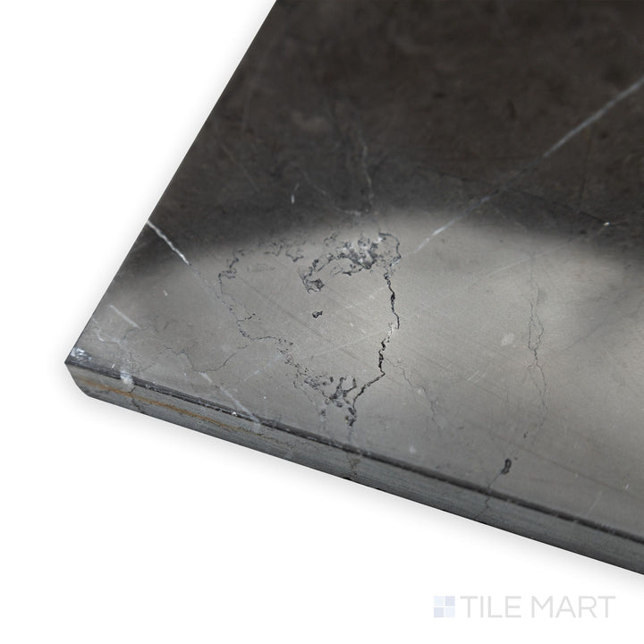 A sleek and polished finish is accentuated in this softly angled corner shot of Graphite Marble 12x24 polished tile, reflecting light beautifully.