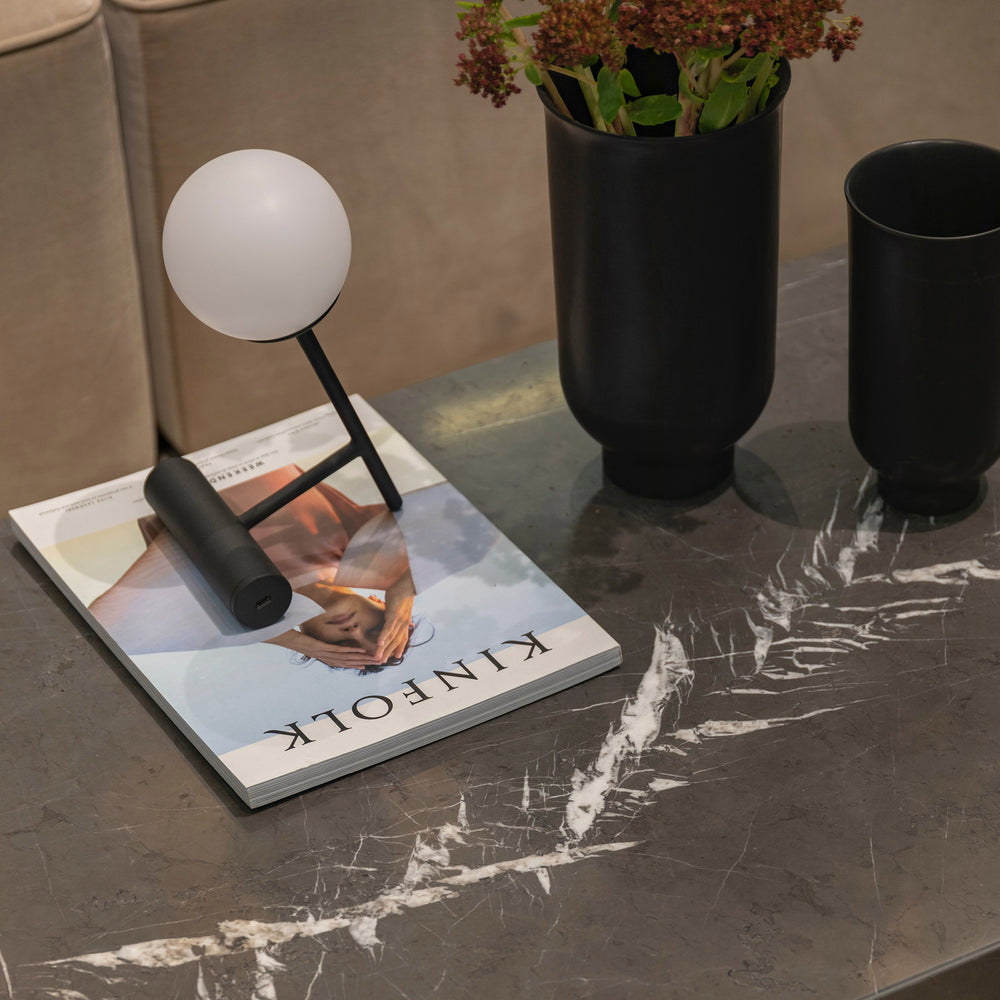 A contemporary roomscene showcasing Graphite Marble 18X18 Honed, bringing a rich dark tone and natural veining for a sophisticated, high-end aesthetic.