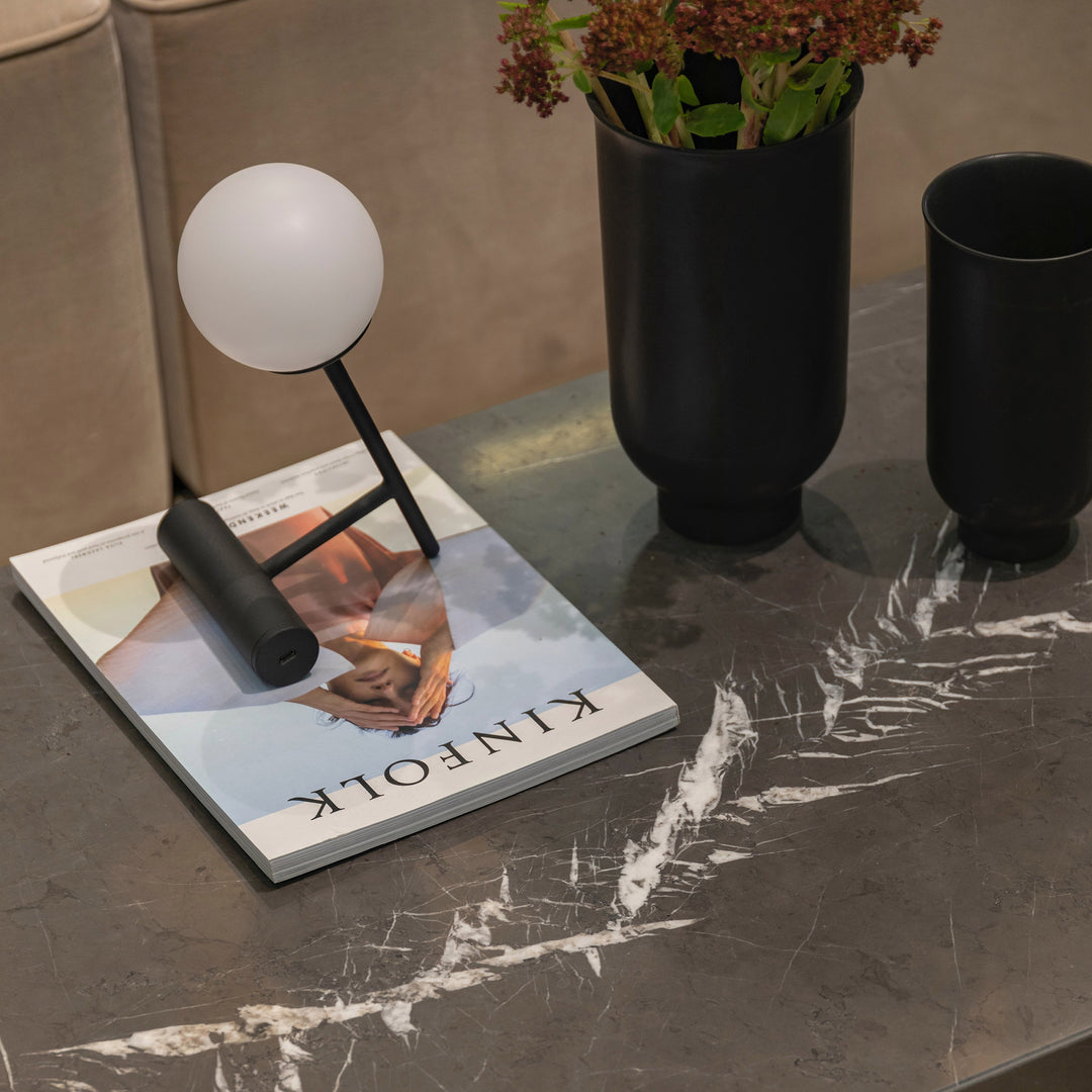 A contemporary roomscene showcasing Graphite Marble 18X18 Honed, bringing a rich dark tone and natural veining for a sophisticated, high-end aesthetic.