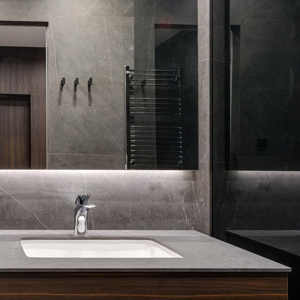 A deep graphite-hued marble with a honed finish adds sophistication and natural texture, effortlessly styled with Graphite Marble 18x18 honed.
