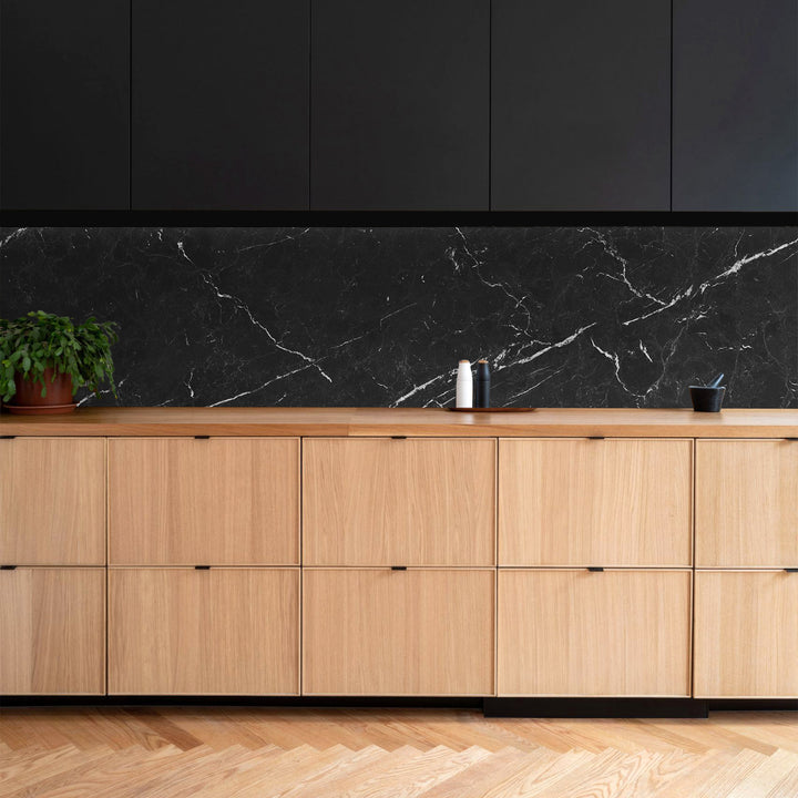 A modern and elegant setting featuring Negro Marquina Marble 3X6 Honed, where deep black marble with striking white veins creates a bold, timeless contrast.