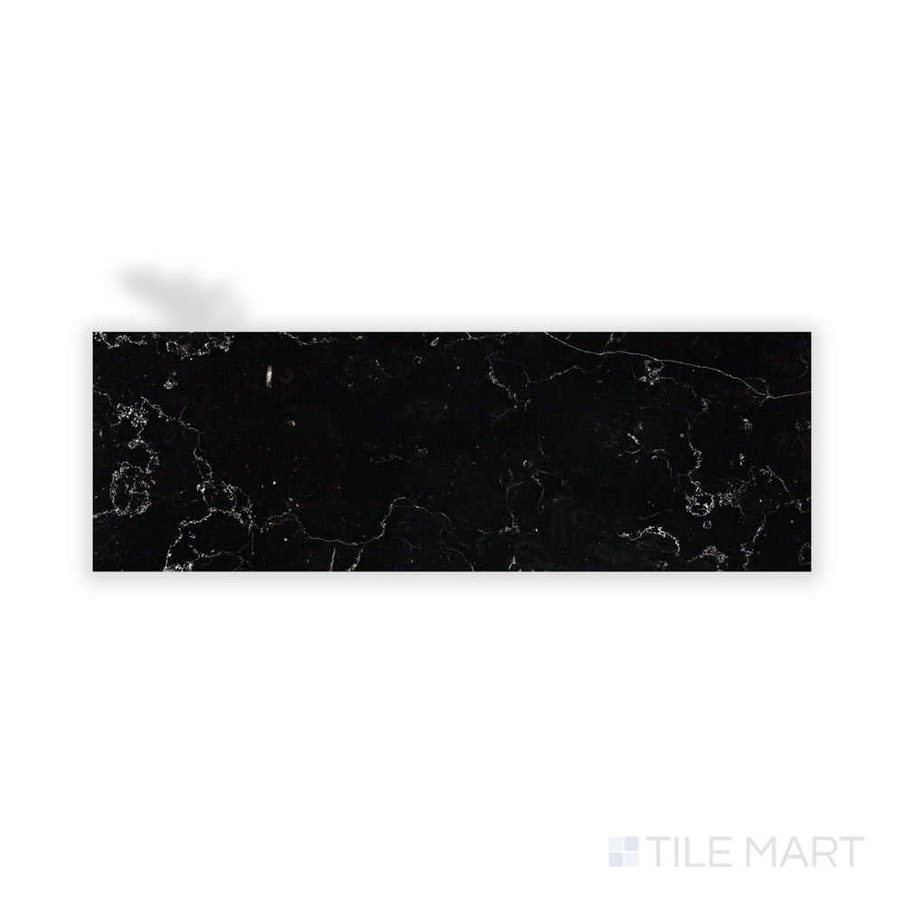 Close-up shot of Negro Marquina Marble 4X12 Honed Tile, presenting a smooth matte finish with naturally occurring white streaks.