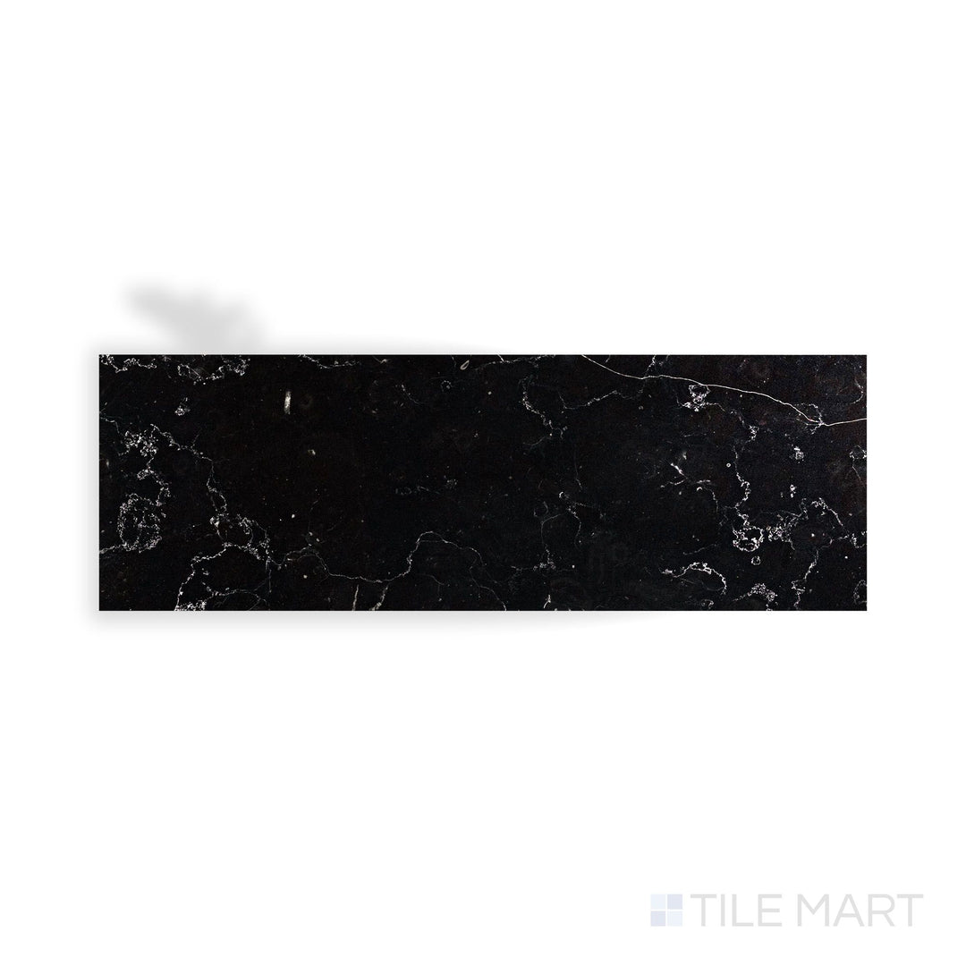An intricate look at Negro Marquina Marble 4X12 Polished Tile, highlighting its deep black hue with a mirror-like surface.