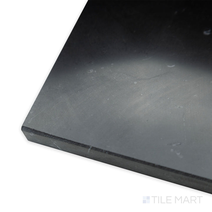 At an angled corner view, the Negro Marquina Marble 4x12 polished tile reflects light beautifully, enhancing its deep black surface and striking white veining.