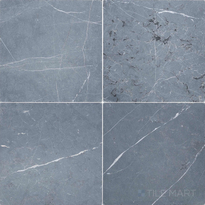 Top-down view of Negro Marquina Marble 12x12 tumbled tile, featuring a rustic surface with softened edges and natural veining.