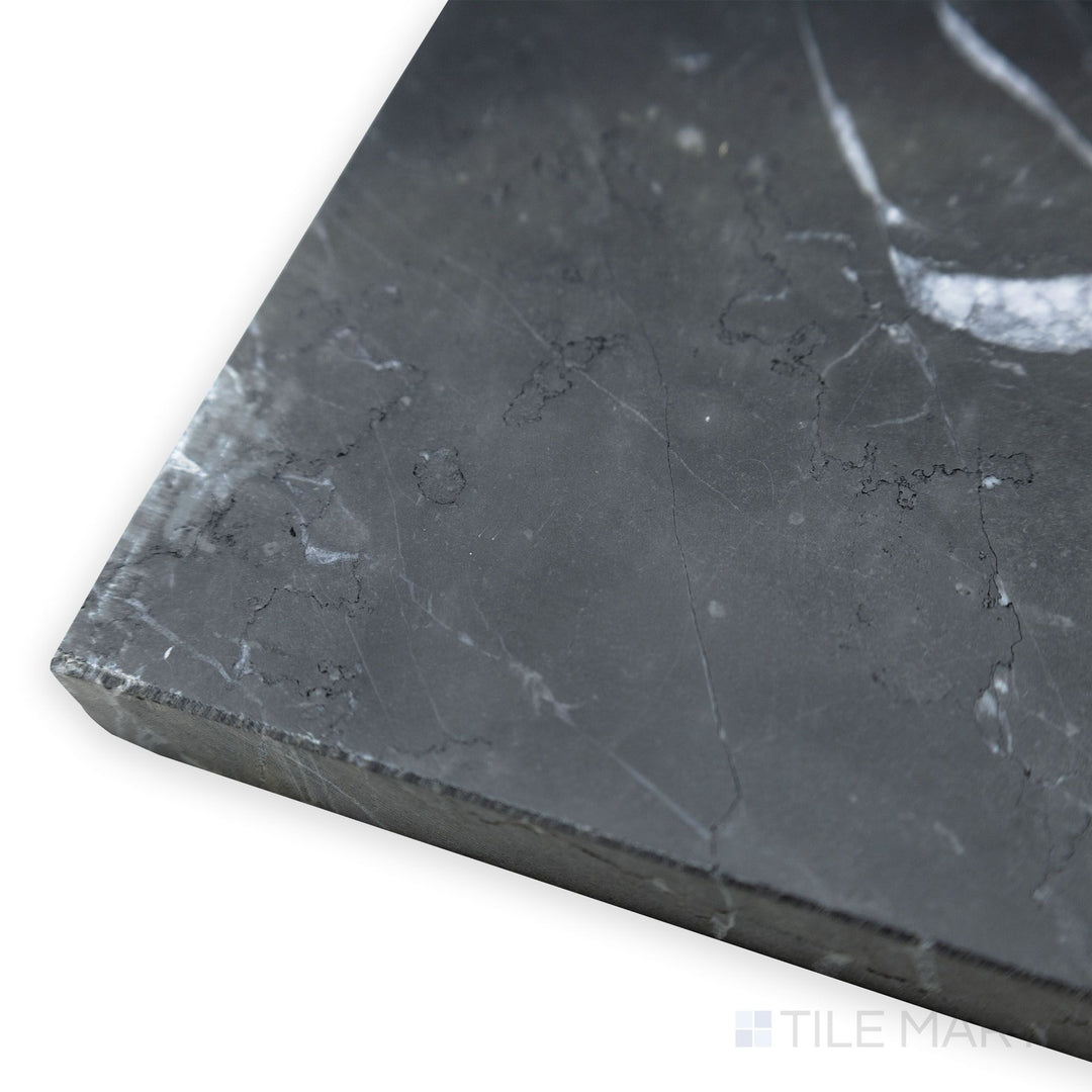 A spacious corner angle enhances the smooth surface of the Negro Marquina Marble 12x24 honed tile, offering a balanced blend of sophistication and modernity.