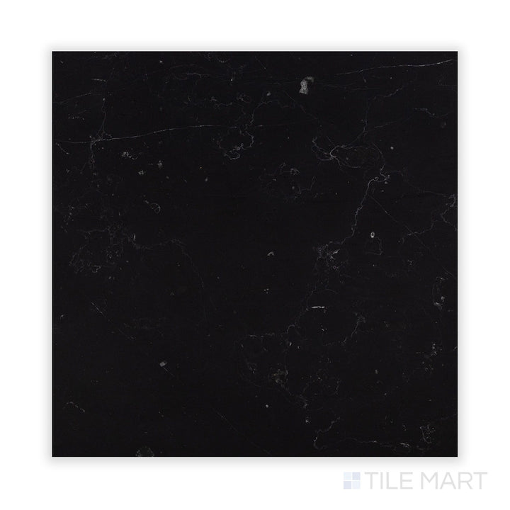 A zoomed-in look at Negro Marquina Marble 18X18 Honed Tile, presenting a velvety matte texture with naturally contrasting white veins.