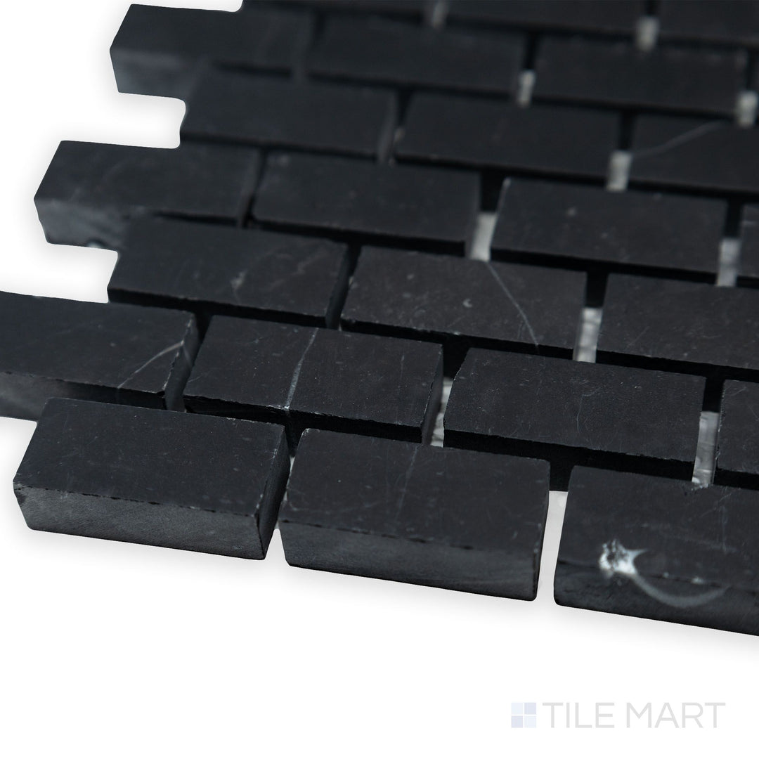 A refined brick pattern is showcased in this angled corner shot of Negro Marquina Marble 5/8x1-1/4 brick honed mosaic, where its honed finish softens the contrast.