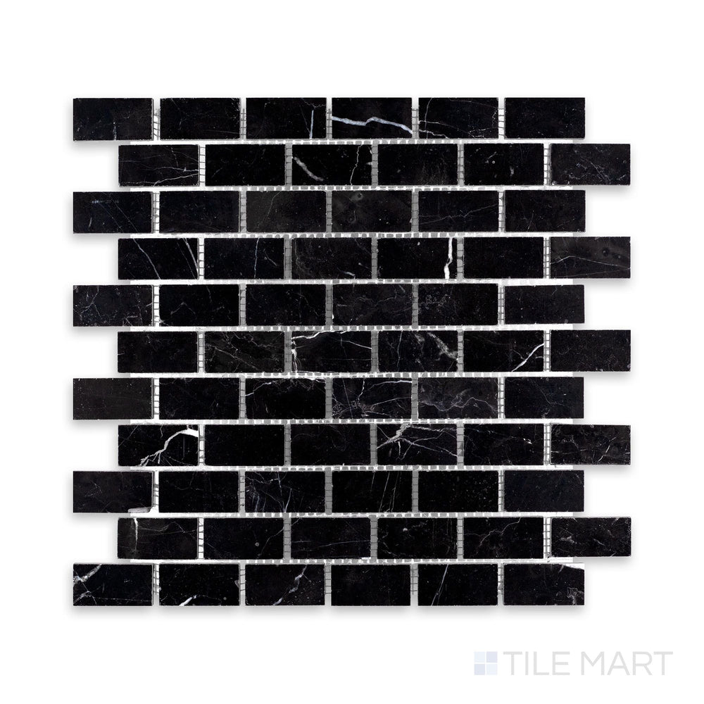 A detailed shot of Negro Marquina Marble 1X2 Brick Honed Mosaic, showcasing its deep black surface with a sophisticated matte effect.