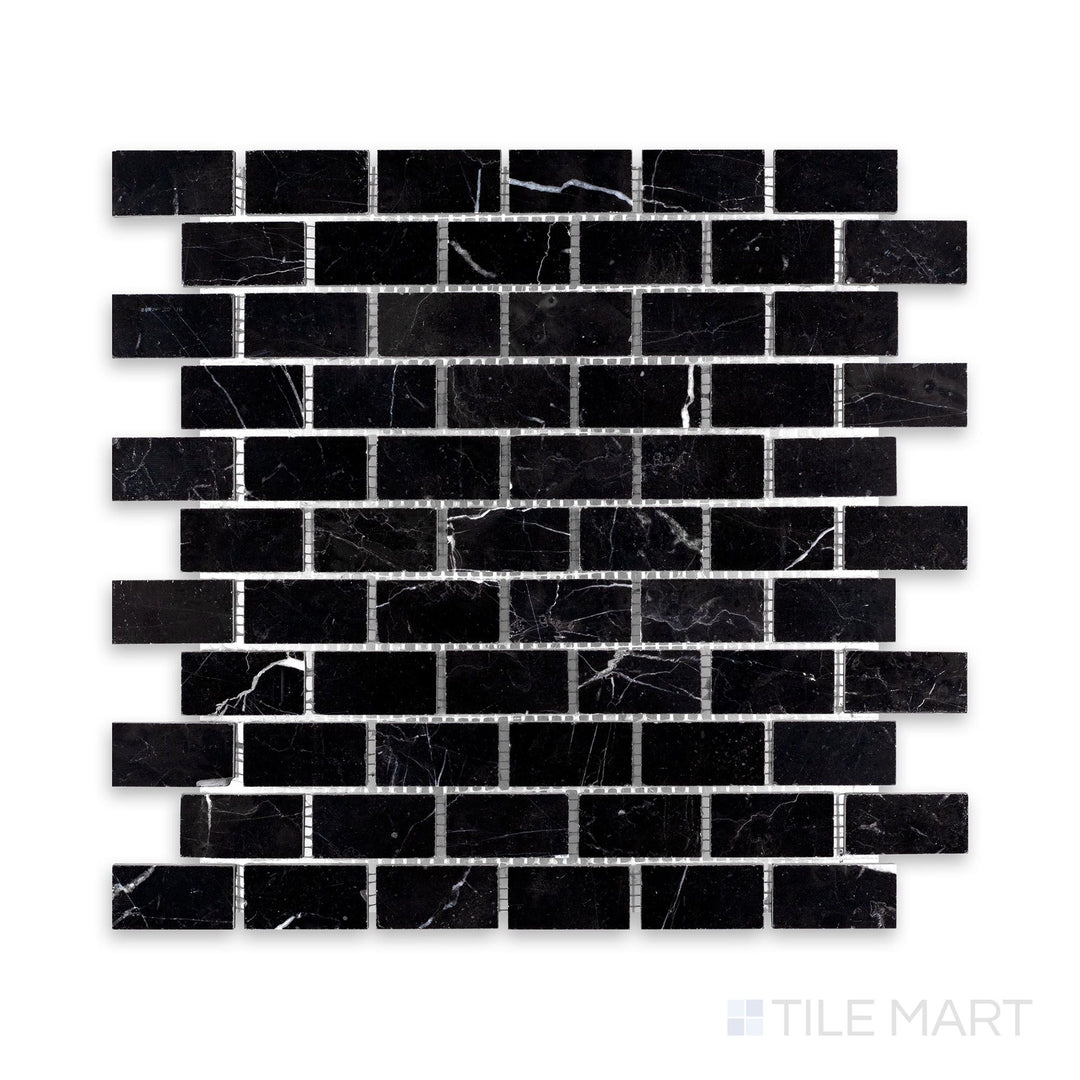 A detailed shot of Negro Marquina Marble 1X2 Brick Honed Mosaic, showcasing its deep black surface with a sophisticated matte effect.