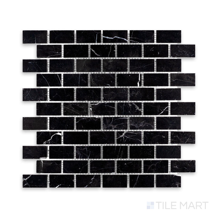 A detailed shot of Negro Marquina Marble 1X2 Brick Honed Mosaic, showcasing its deep black surface with a sophisticated matte effect.