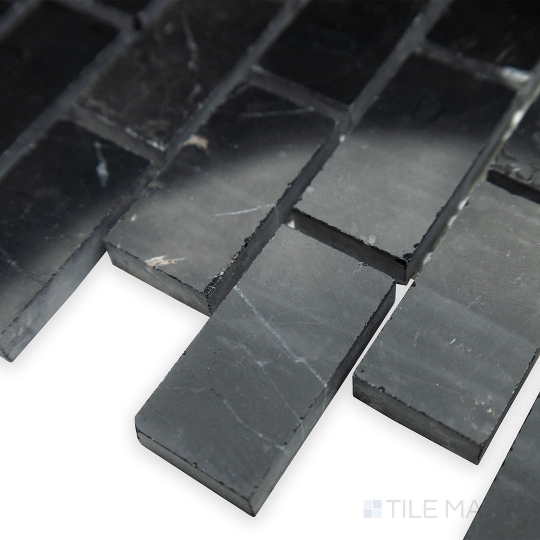 From a polished and structured angle, the Negro Marquina Marble 1x2 brick polished mosaic gleams in this corner shot, adding a modern and sleek touch.