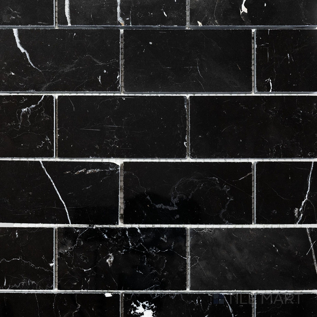 Flat-lay shot of Negro Marquina Marble 2x4 brick polished mosaic, featuring a sleek polished finish that highlights the bold veining patterns.