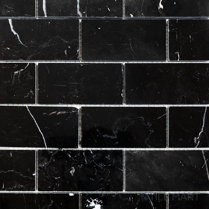 Flat-lay shot of Negro Marquina Marble 2x4 brick polished mosaic, featuring a sleek polished finish that highlights the bold veining patterns.