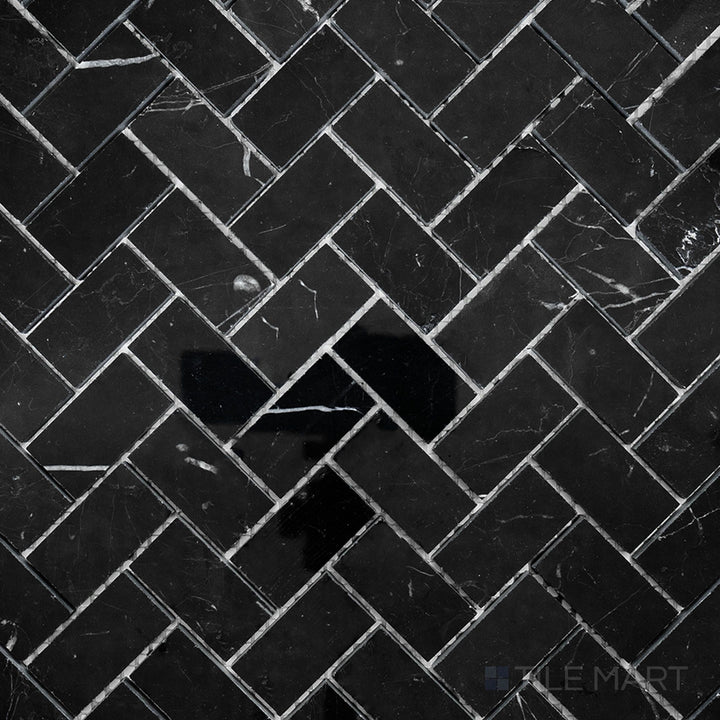 Overhead image of Negro Marquina Marble 1x2 herringbone polished mosaic, showcasing a glossy herringbone pattern that enhances the rich black tones.