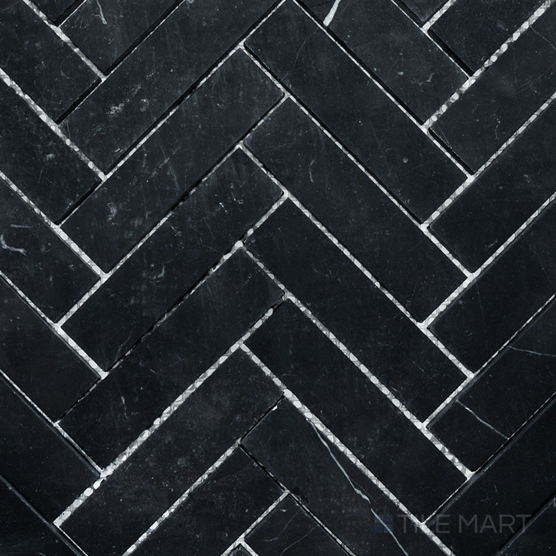 Overhead image of Negro Marquina Marble 1x4 herringbone honed mosaic, showcasing a refined herringbone arrangement with a soft honed matte surface.