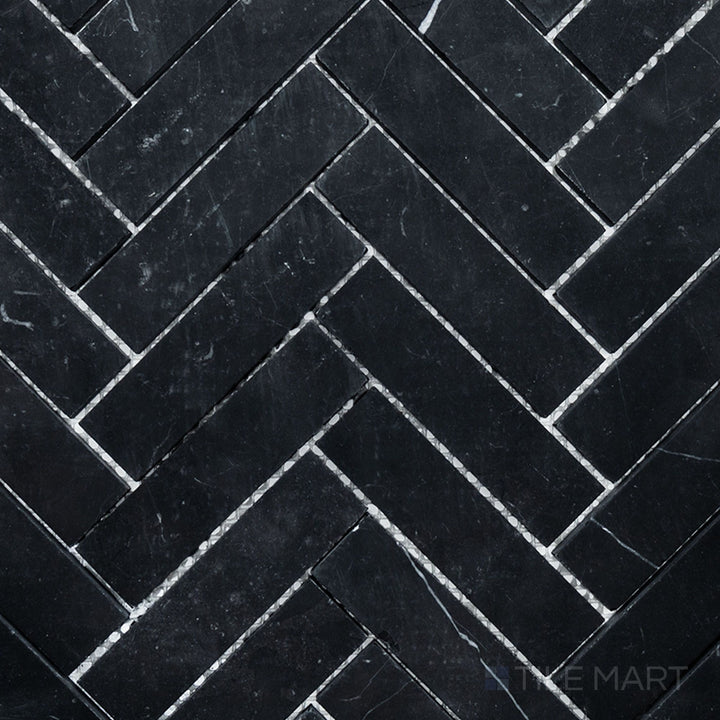 Overhead image of Negro Marquina Marble 1x4 herringbone honed mosaic, showcasing a refined herringbone arrangement with a soft honed matte surface.