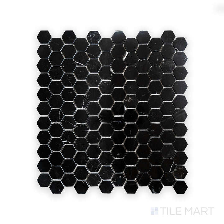 A high-resolution close-up of Negro Marquina Marble 1" Hexagon Polished Mosaic, featuring a sleek black surface with sharp contrasting veins.