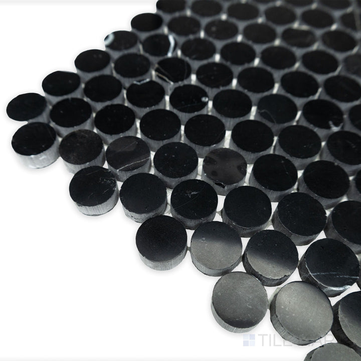 A smooth, polished glow captures the timeless appeal of Negro Marquina Marble 3/4" penny round polished mosaic in this softly angled corner shot.