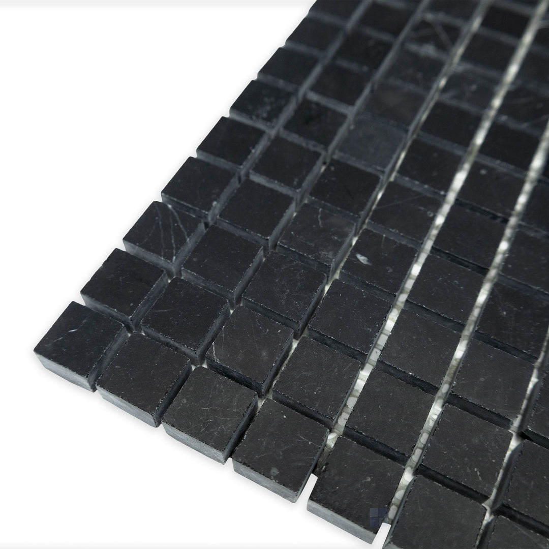A refined square grid layout takes shape in this angled corner perspective of Negro Marquina Marble 5/8" square honed mosaic, where the matte surface adds depth to the pattern.