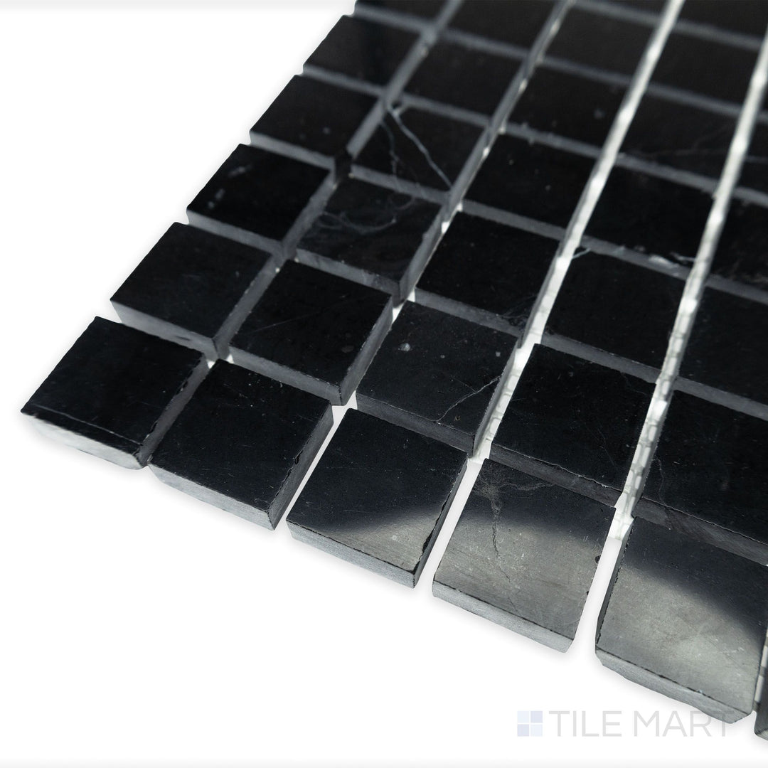 A high-gloss finish brings out the geometric precision of Negro Marquina Marble 1" square polished mosaic in this softly angled corner shot.