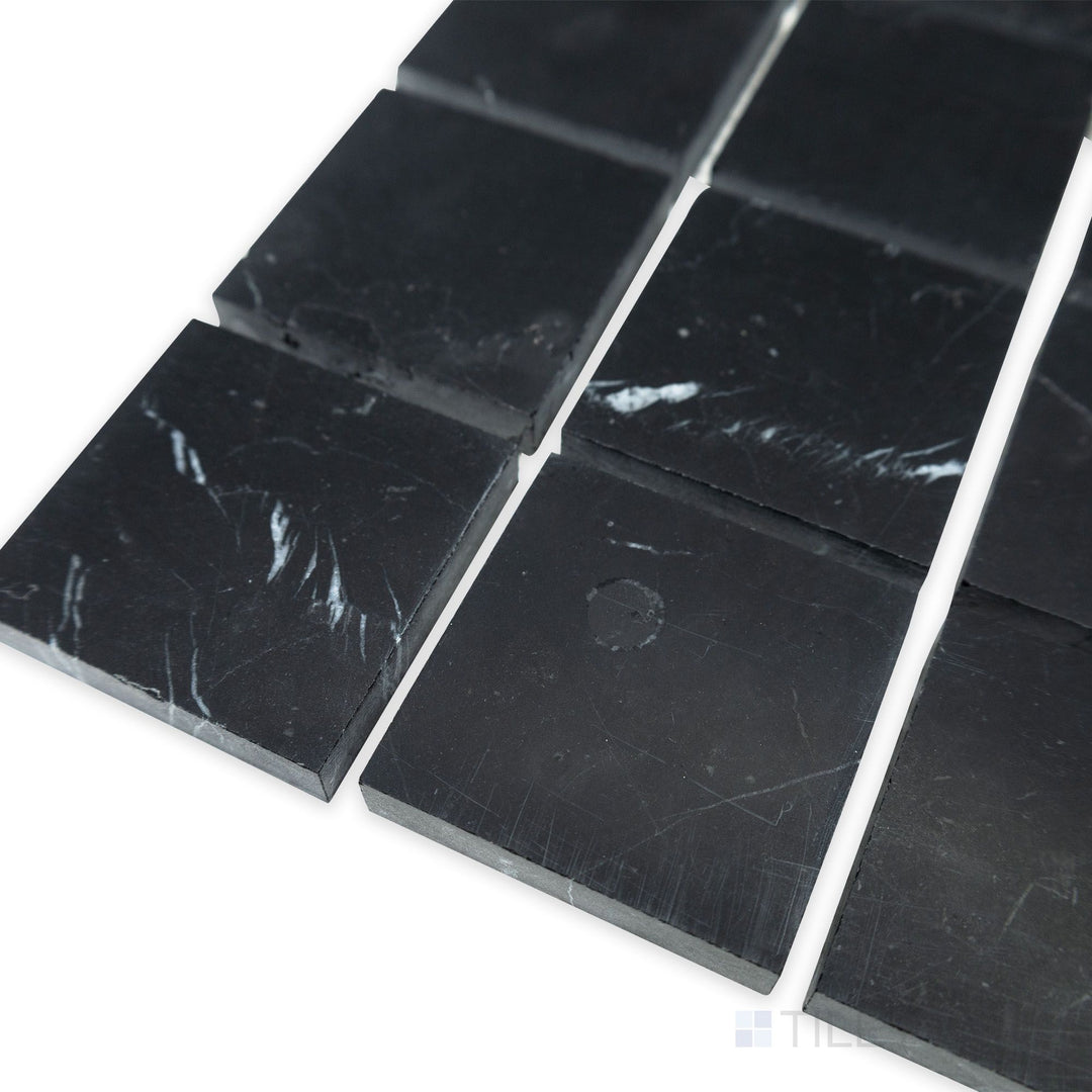 A modern square arrangement comes to life in this corner shot of Negro Marquina Marble 2" square honed mosaic, where the smooth matte surface adds a contemporary touch.